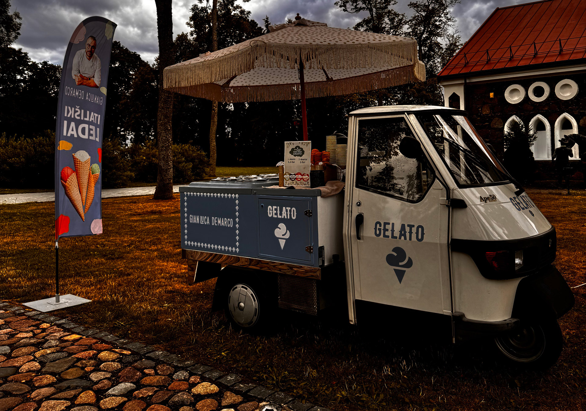 Piaggio Ape 50 gelato ice cream truck — full side view with blue freezer box and fringed parasol